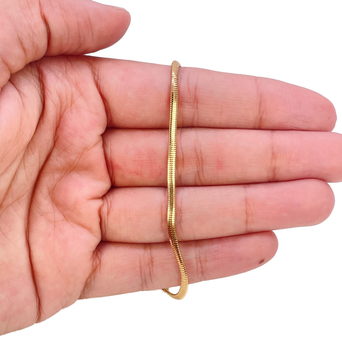 Close-up of smooth high polish links on 22ct gold snake chain bracelet