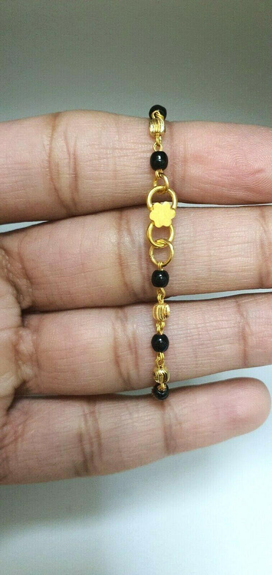 22ct Yellow Gold Baby Bracelet Black-beads With Diamond Cut Design