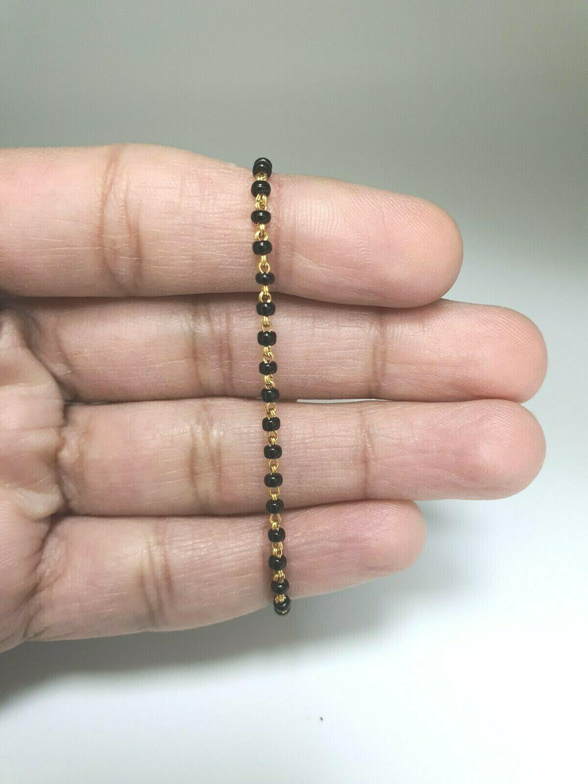 18ct Yellow Gold Baby Bracelet Black Beaded With Diamond Cut Design