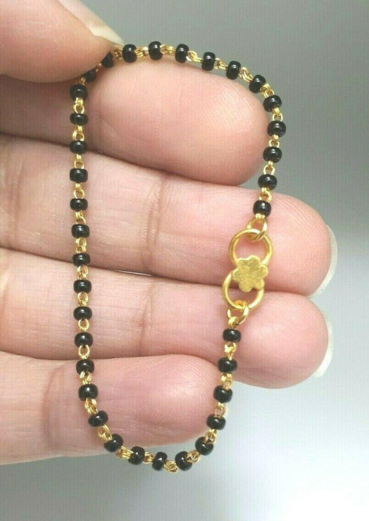 18ct Yellow Gold Baby Bracelet Black Beaded With Diamond Cut Design