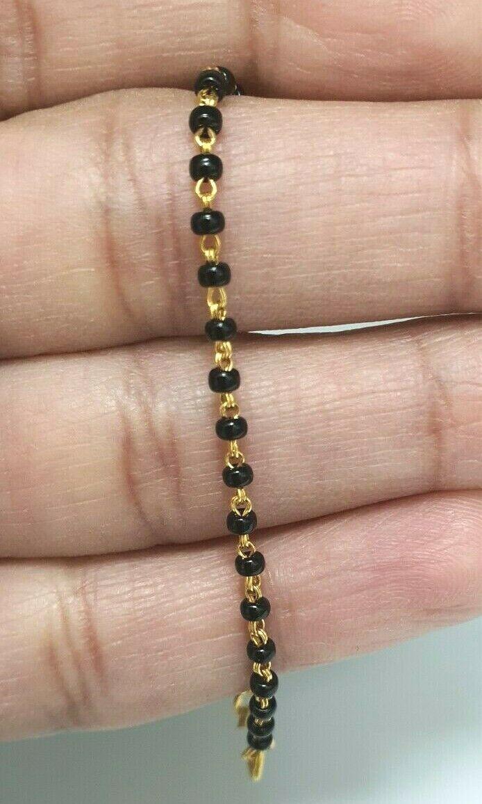 18ct Yellow Gold Baby Bracelet Black Beaded With Diamond Cut Design